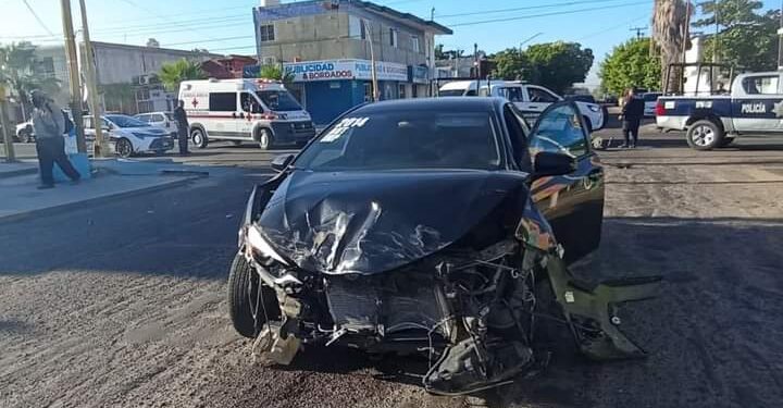 Aparatoso accidente en 5 de Mayo y Altamirano en La Paz Baja California Sur una mujer queda dentro del automóvil rojo ya que la puerta no puede abrir ella se encuentra bien, deshaciendo el peritaje para deslindar responsabilidades al parecer alguien se pasó el alto